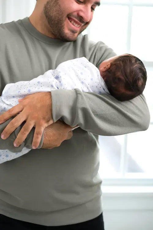 Father Holding Baby in HALO Baby Sleeping Bag SleepSack - Midnight Moons