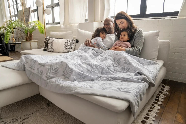 Parents and Children on Sofa with Weighted Blanket